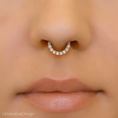 "Minimalist with a classic design, this 14k gold diamond septum hoop is perfect for a touch of everyday glam. Materials: * 14K Solid Gold (Weight: 0.85g) - Available in yellow, rose or white gold. * Genuine white diamonds (Weight 0.15ct VS-SI/G-H) Measurements: Inner diameter of the ring: 0.3\" - 8mm Outer diameter: 0.43\" - 11mm Wire thickness: 18g - 1mm Number of diamonds: 10 Diamond size: 1.5mm * Nickel free and hypoallergenic Please note: This design is ready to ship in 14k yellow gold. Made Diamond Septum Ring, Diamond Septum Piercing, Elegant White Gold Nose Rings In Sterling Silver, Elegant White Gold Sterling Silver Nose Ring, Elegant Wedding Septum Ring With Prong Setting, Elegant Wedding Septum Ring, Elegant Diamond Septum Ring For Wedding, Elegant 14k Gold Septum Ring For Anniversary, Elegant 14k Gold Round Septum Ring