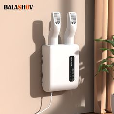 two electric toothbrushes are plugged into the wall