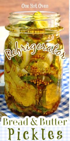 a jar filled with pickles sitting on top of a blue and white checkered table cloth