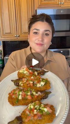 a woman holding a plate with food on it