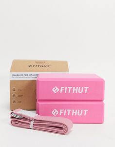 two pink boxes sitting next to each other on top of a white surface with a cord