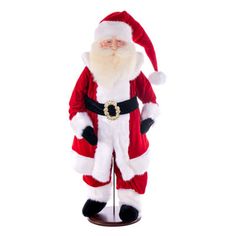 a santa clause figurine is standing on a stand with his hands in his pockets