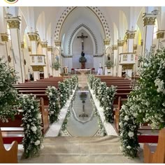 the inside of a church decorated with flowers and greenery