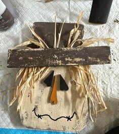 a scarecrow head made out of wood planks