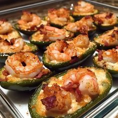 several stuffed peppers with shrimp and cheese on them