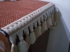 the bed is made up with many tassels