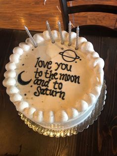 a birthday cake with the words love you to the moon and to saturn on it