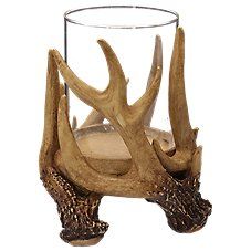 a glass with some deer antlers in it's mouth and on its side