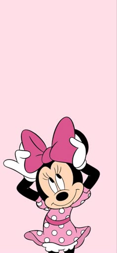 minnie mouse with pink and white polka dots on it's head, standing in front of