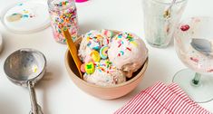 a bowl filled with ice cream and sprinkles on top of a table