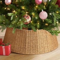 a christmas tree with ornaments in a basket