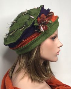 This boiled wool winter hat will be the ideal finish to your outfit. The hat is colored green, purple, orange and brick. On the side of the hat a flower worked in wool, the background is embroidered in matching color wool. Available in several colors and in two sizes for the head circumference 53-57 and 58-60cm stretchable, covers the ears well. Pleasant, soft and warm. Without the lining. It is possible to coordinate it with mittens and scarf. Dry clean or by hand in cold water. Green Winter Hat, Country Hats, Funky Hats, Woman Hat, Hat Fits, Wool Caps, Unique Hats, Wool Winter, Boiled Wool