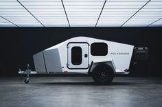 an off - road camper trailer parked in a garage