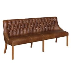 a brown leather couch sitting on top of a wooden legrests and arm rest