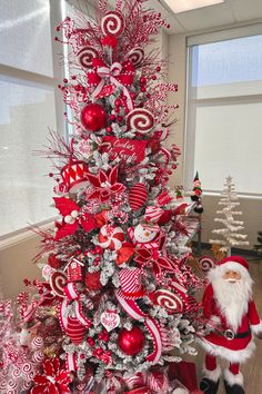 a christmas tree decorated with red and silver ornaments