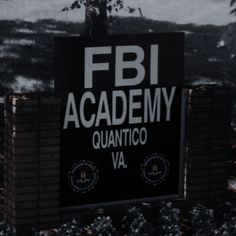 a black and white sign that reads fbi academy quanntico va on it