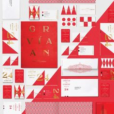 red and gold wedding stationery with matching envelopes, cards, and other items