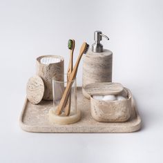 a bathroom set consisting of soap dispenser, toothbrush holder and cup