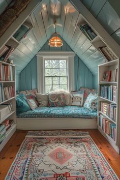 a window seat in the corner of a room with bookshelves and rugs