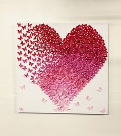 a heart made out of pink and red butterflies