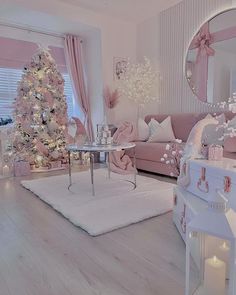 a living room decorated in pink and white with a christmas tree on the corner table