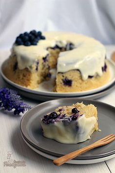 two plates with blueberry cheesecakes on them