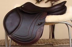 a brown and white saddle sits on a chair