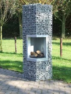 an outdoor fireplace made out of cement blocks