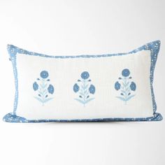 an embroidered pillow with blue flowers on it