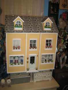 a doll house sitting on top of a table