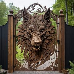 a wooden gate with a carved wolf's head on it