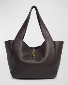 Saint Laurent "Bea" tote bag in deer leather     Shoulder straps     Open top with YSL logo strap     Interior, one zip pocket     Golden hardware     Approx. 11"H x 19.6"W x 7.1"D    Professional cleaning recommended    Made in Italy Ysl Bag Tote, Saint Laurent Tote Bag, Ysl Bags Aesthetic, Handbags Outfits, Bag Ysl, Tote Bag Luxury, Bags Tote, Dream Wardrobe Clothing, Luxury Tote Bag