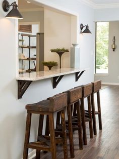 an empty room with stools and shelves on the wall