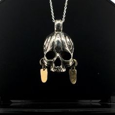 Discover the perfect blend of bold style and symbolic protection with this Tribal Skull Pendant Necklace by Judicael Vales , uniquely designed with hanging earrings. This handcrafted piece is more than just a pendant--it's a statement. The intricately detailed skull holds two earrings that dangle directly from the pendant, creating a striking and cohesive design. Crafted from white metal silver-plated and brass, this amulet not only symbolizes protection but also exudes a rugged, tribal-inspired aesthetic. Designed for unisex wear, this necklace is perfect for anyone seeking a meaningful accessory with a powerful edge. The pendant hangs on a durable chain, making it an ideal piece for everyday wear or special occasions. Whether you're drawn to the spiritual symbolism of the skull or simply Skull Pendant Necklace, Skull Pendant, Bold Style, Hanging Earrings, Necklace Earring Set, White Metal, Earring Set, Jewelry Necklace Pendant, Handmade Jewelry