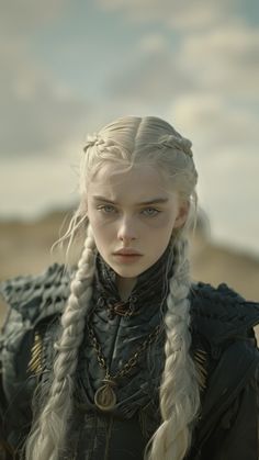 a woman with long white hair and braids on her head standing in the desert