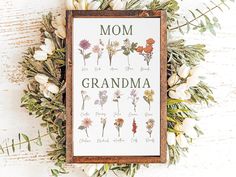 a cross stitch pattern with flowers and the words'mom, grandma'on it