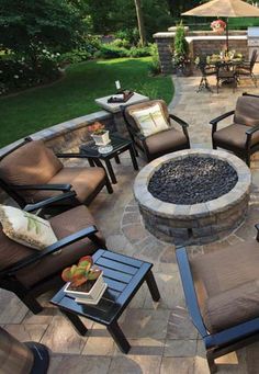 a fire pit surrounded by chairs and tables