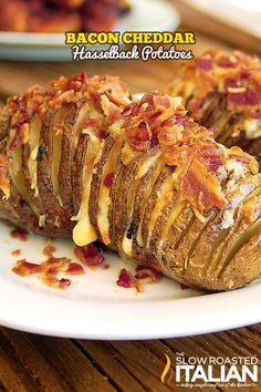 baked potatoes with cheese and bacon on a white plate sitting on a wooden table top