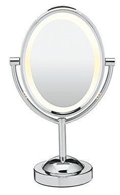 an illuminated mirror on a metal stand with a white light in the middle of it