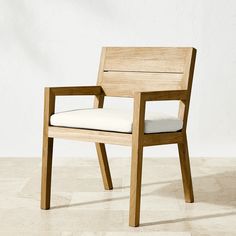 a wooden chair sitting on top of a tile floor