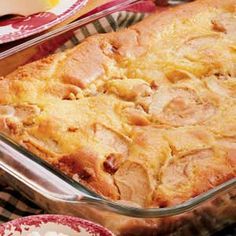 a casserole dish with meat and cheese in it on a red and white checkered table cloth