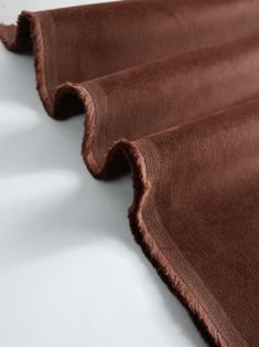 the fabric is brown and has ruffled edges