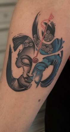 a tattoo on the arm of a person with a clock and two faces in it