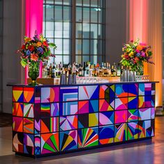 a brightly colored bar with vases and bottles on it