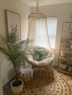 a room with a hammock, potted plants and pictures on the wall