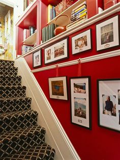 the stairs are lined with pictures and photographs