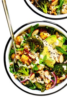 two white bowls filled with salad and topped with broccoli