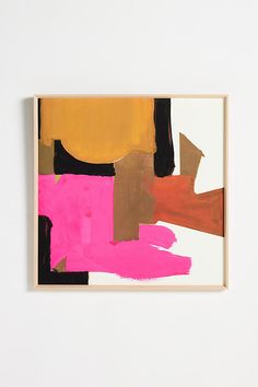 an abstract painting with pink, yellow and brown colors on a white wall next to a wooden frame