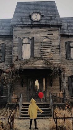 a person standing in front of an old house