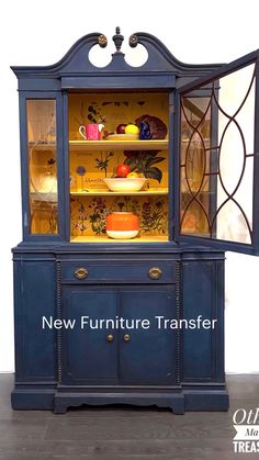 a blue china cabinet with glass doors and shelves